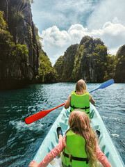 Family vacations - mom and kid kayaking travel in Philippines healthy lifestyle wellness active...