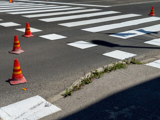 FRESH Road Marking and Pedestrian Crosswalk with Traffic Cones in City Street