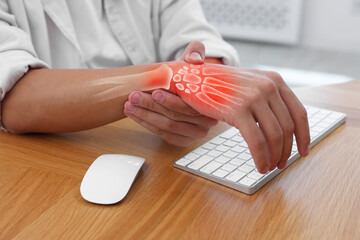 Arthritis. Man suffering from wrist pain at table indoors, closeup. Illustration of joint...
