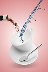 Instant coffee making. Combining granules from sachet and water in cup against pink background