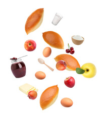 Baked patties and ingredients falling on white background