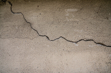 Cracked concrete wall texture with deep fracture