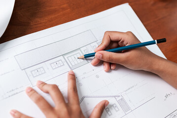 Architectural design drawing in progress at home office sketching floor plans creative workspace aerial view