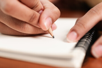 Creative writing process hands writing in a notebook intimate setting close-up perspective artistic inspiration