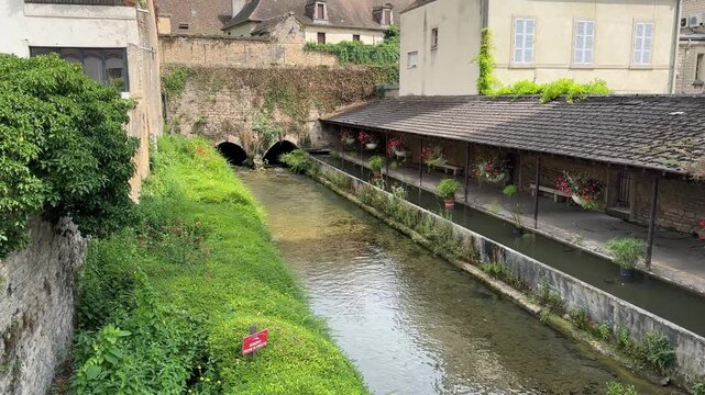 River and Medieval Structure in Beaune, France &ndash; Scenic View of Historic Architecture by the Water


