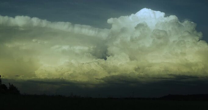 Massive White Supercell Cumulonimbus Clouds Rapidly Sailing Across a Deep Blue Sky in 4K TimeLapse Capturing Explosive Growth Moving Storm Structures and Rolling Cloud Turbulence Over Open Terrain