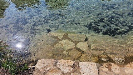 Sunlight Reflected on Shallow River with Stone Edge