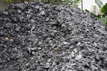 Pile of Crushed Black Coals and Gravel in Outdoor Construction Setting