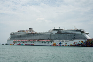 cruise ship docked at a scenic waterfront park 