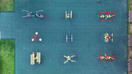 Senior outdoor fitness equipment in urban park from aerial view