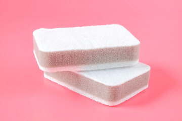 Two cleaning sponges on color background.
