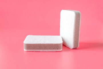 Two cleaning sponges on color background.