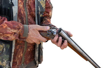 Midsection of man unloading shotgun while standing on field