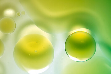 Abstract composition of green and yellow liquid bubbles on surface