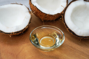 Coconut Oil in glass jar with Coconut cut open in half. Pure homemade extra virgin coconut oil from...