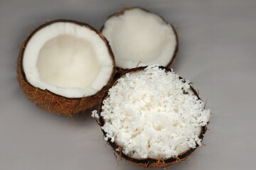 Shredded young coconut is placed on a wooden plate on a sack. It has white coconut flesh that looks delicious and appetizing.