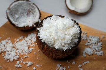 Coconut halves with shell and pulp on the background, of an open coconut with white flesh. Organic healthy food concept. Selective focus.