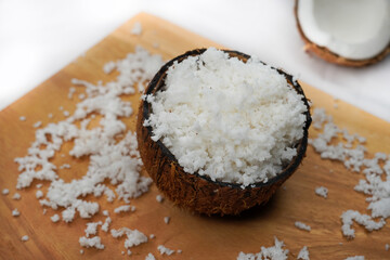 Coconut halves with shell and pulp on the background, of an open coconut with white flesh. Organic healthy food concept. Selective focus.