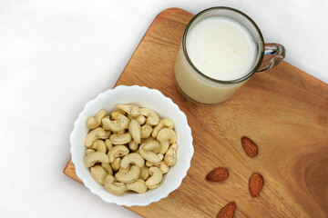 Vegan, plant based, non dairy milk table scene. Coconut, nut in milk bottles with scattered...