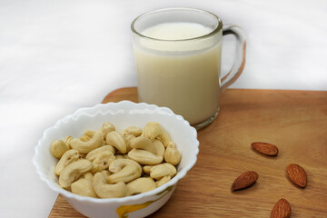 Vegan, plant based, non dairy milk table scene. Coconut, nut in milk bottles with scattered...