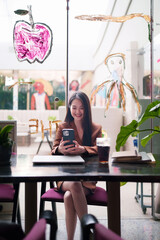 Modern Asian Adult Professional Engaged on Smartphone in Stylish Cafe for Remote Work and Digital Communication
