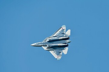 This image captures a fighter jet in the midst of a high-performance maneuver, possibly during an...