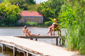An old brick house on the other side of the river.