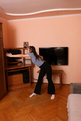 Beautiful girl doing exercises at home. Home workouts.