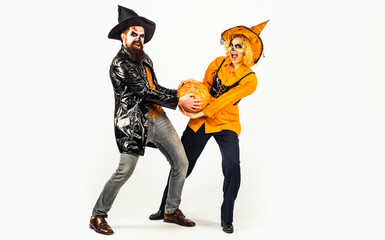 Party and festivals on Halloween. Halloween couple with pumpkin and Halloween makeup. Man and woman...
