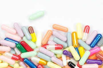 Colorful pharmaceutical capsule pile for medicine or vitamin supplement concepts. A vibrant...