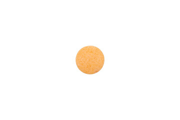 Orange tablet of vitamin C, a health supplement for immunity support. Macro closeup of a single round pill or medicine with texture, isolated on white background with clipping path.