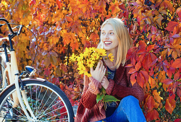 Autumn girl in good mood posing outdoor. Dreamy girl. Beauty model, young beautiful woman hold autumn leaves. Romantic woman in autumn park. Autumn fall concept.