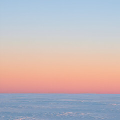 Fototapeta premium Soft Pastel Sunset Sky Over a Snow Covered Plain Peaceful Serene Nature