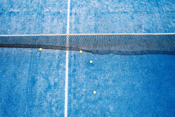 overhead perspective of an empty blue sports court with game equipment