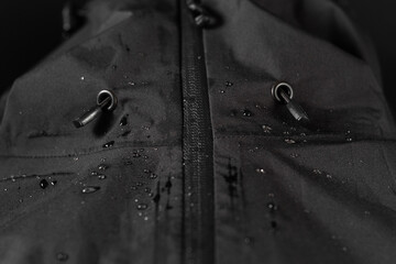 Waterproof fabric for outerwear. Water drops on the fabric. Outerwear accessories.