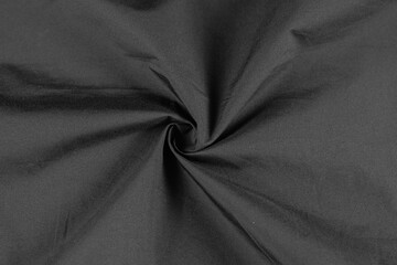 Photo of black fabric on black. Crumpled black fabric. Isolated photo of fabric.