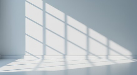 Obraz premium Sunlight casts geometric shadows on a white room with a large window.