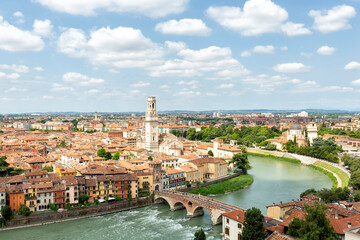 Fototapeta premium Ponte di Pietra over the Adige River and Lungargine dell'Adige in Verona. This ancient stone bridge offers scenic views and connects to the riverside promenade