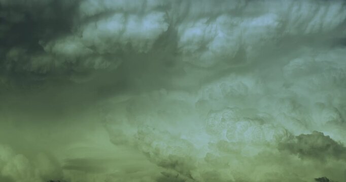 Timelapse of a detail of a massive growing white cumulonimbus cloud forming supercell