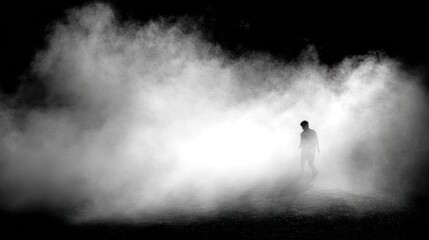 Fototapeta premium Silhouette of a figure walking through thick fog