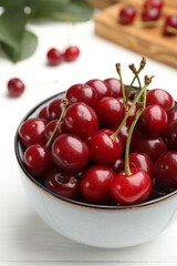 Fresh ripe cherries on white wooden table, closeup
