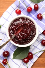 Tasty cherry jam and fresh fruits on wooden table, flat lay