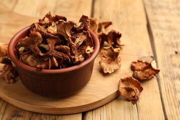 Dried chanterelle mushrooms on wooden table, closeup