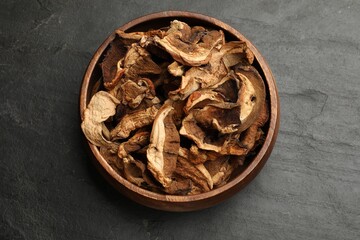 Dried chanterelle mushrooms on wooden table, top view