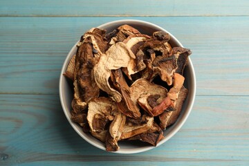 Dried chanterelle mushrooms on blue wooden table, top view