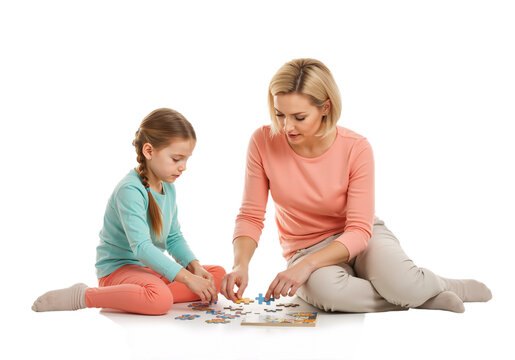 Mother and daughter doing puzzle on floor - Powered by Adobe