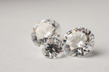 Many shiny diamonds on light background, closeup