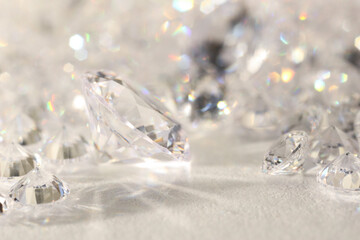 Many shiny diamonds on light background, closeup