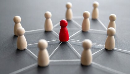 Obraz premium A visual representation of a leader standing out among a group, symbolizing leadership and unity. The central red figure stands out against the circle of other figures