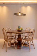 Rustic Dining Table with Fruit Bowl Under Warm Light